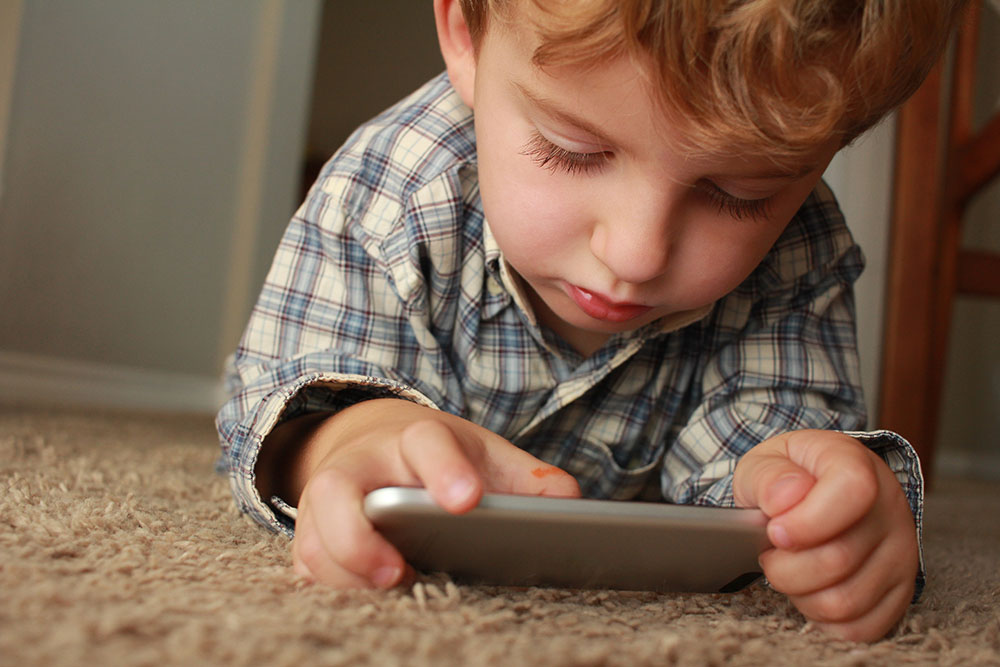 little boy using social media