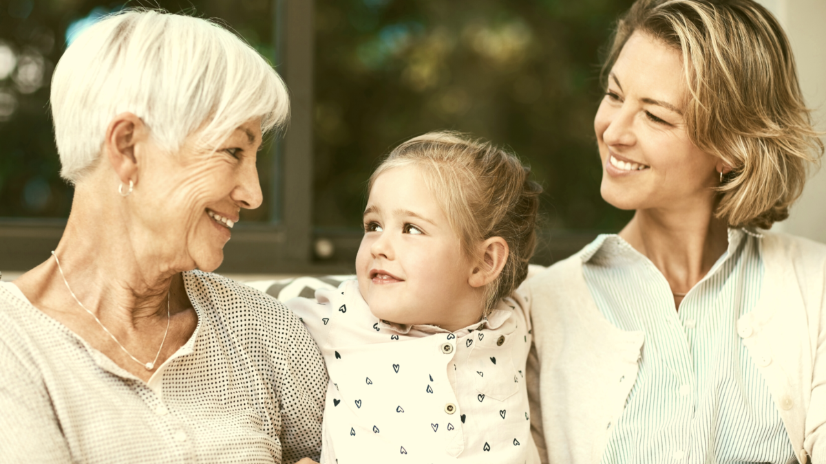 Older woman, baby, and mother talking together