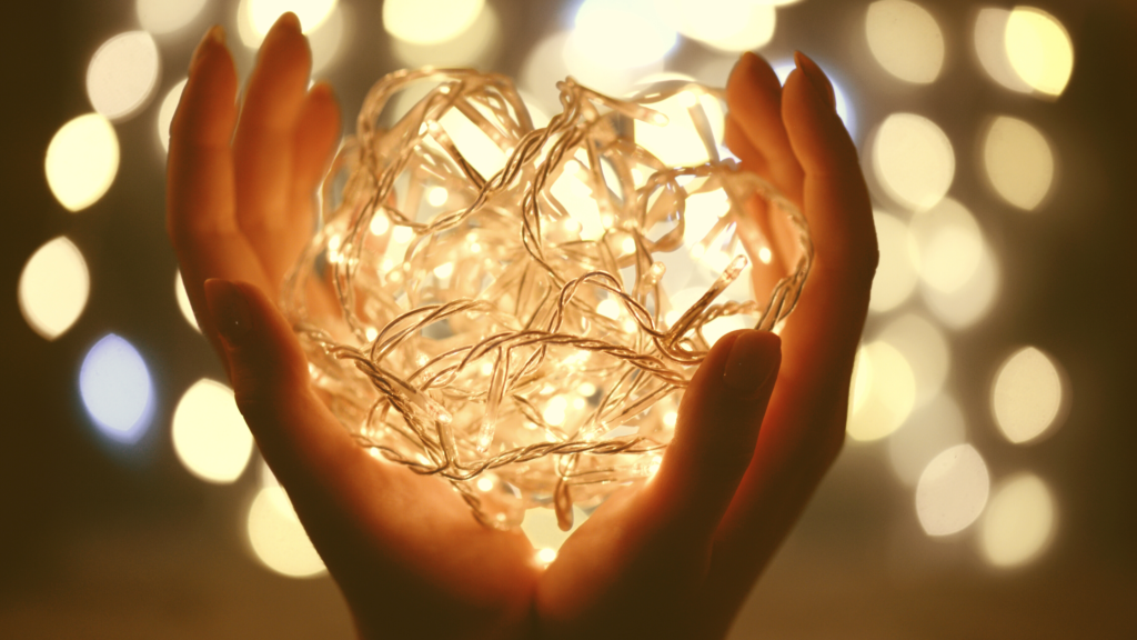 lighted heart ornament in hands